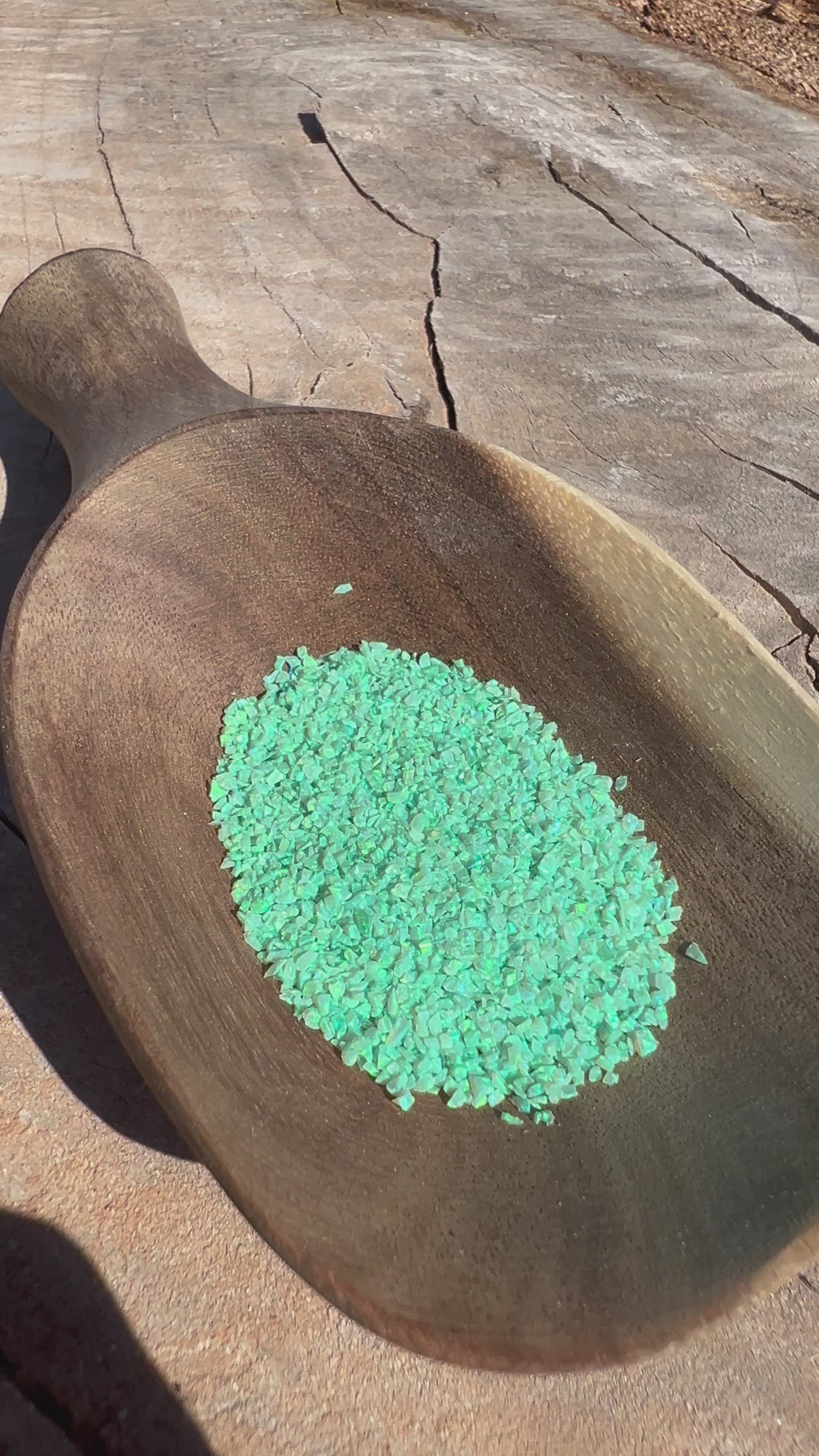Video of Crushed Synthetic Kiwi Opal on wood bowl in full sunlight - Purple Door Alchemy