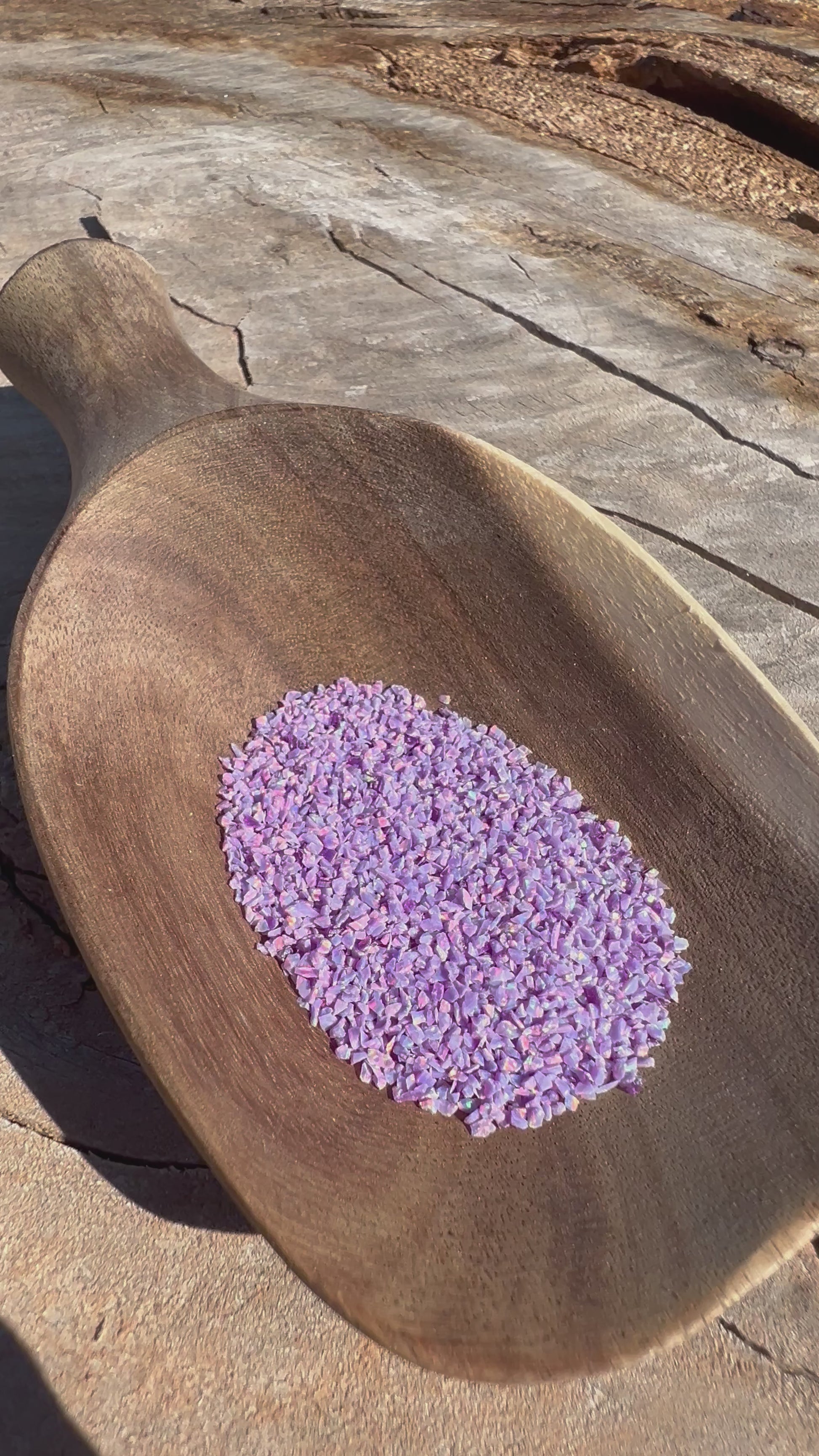 Video of Crushed Synthetic Lavender Opal on wood bowl in full sunlight - Purple Door Alchemy